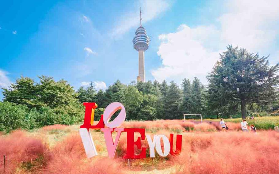 A tower and “LOVE YOU” sign in E-World.